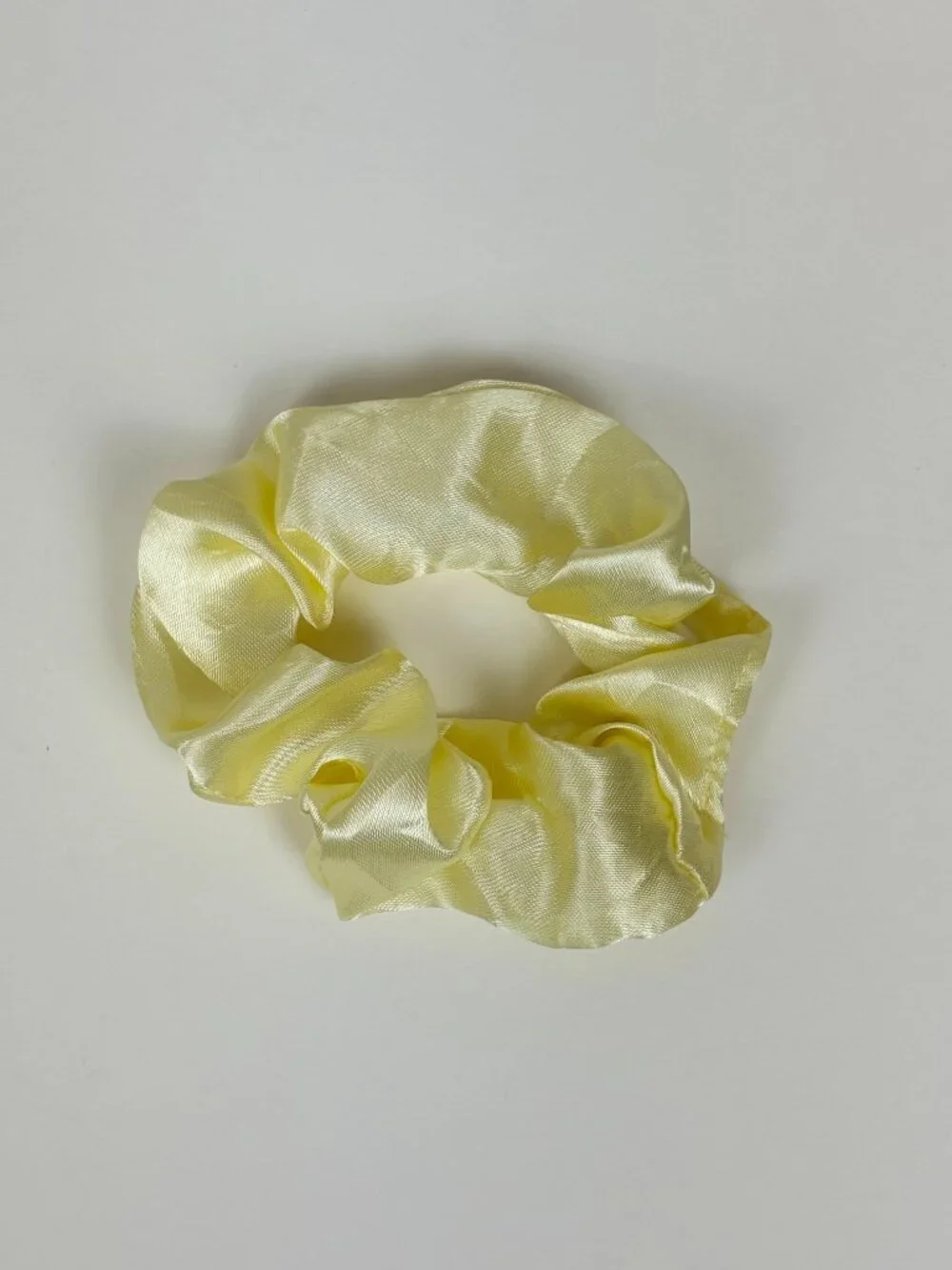 Pale yellow satin scrunchie. New without tags. Never used. Unbranded